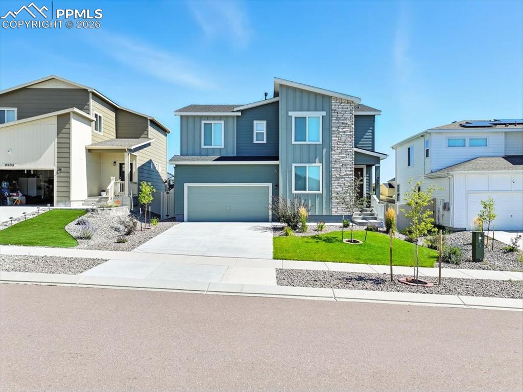 9891 Hidden Ranch Court Peyton, CO 80831 - Photo 2 of 44 a front view of a house with a yard and porch