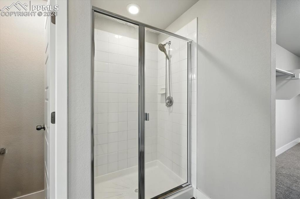 9891 Hidden Ranch Court Peyton, CO 80831 - Photo 23 of 44 a bathroom with a glass door shower