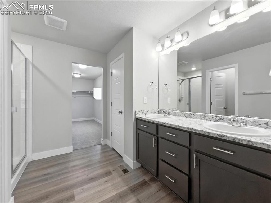 9891 Hidden Ranch Court Peyton, CO 80831 - Photo 24 of 44 a bathroom with a double vanity sink and a mirror