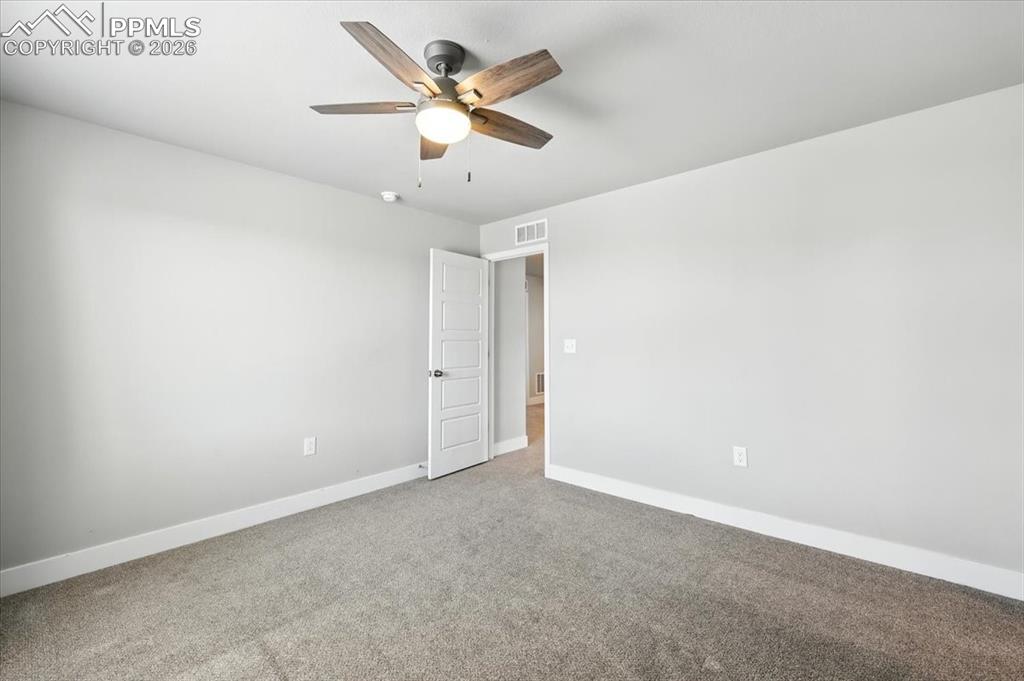 9891 Hidden Ranch Court Peyton, CO 80831 - Photo 33 of 44 an empty room with a ceiling fan and a window