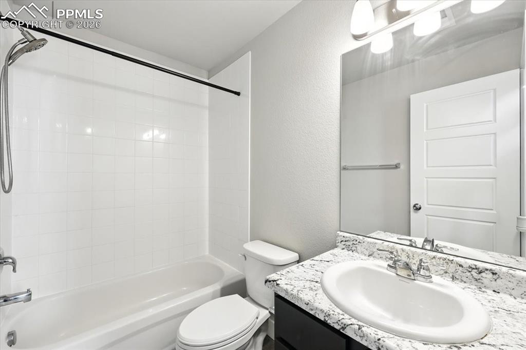 9891 Hidden Ranch Court Peyton, CO 80831 - Photo 34 of 44 a bathroom with a granite countertop sink toilet and shower