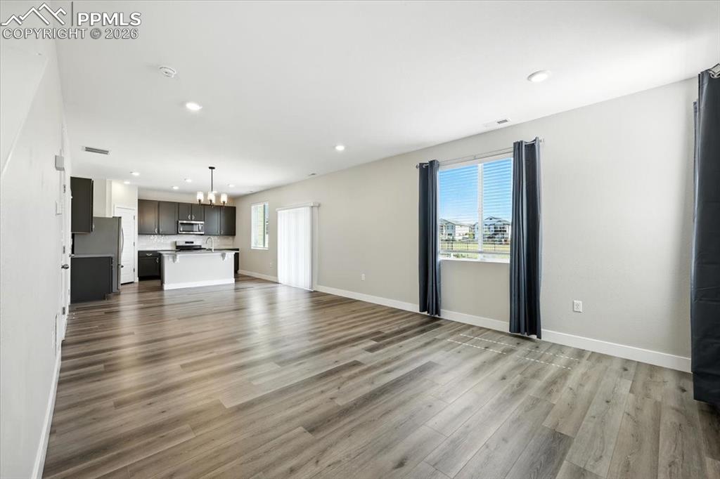 9891 Hidden Ranch Court Peyton, CO 80831 - Photo 6 of 44 a view of kitchen with kitchen island wooden cabinets and refrigerator