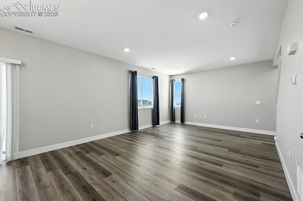 9891 Hidden Ranch Court Peyton, CO 80831 - Photo 7 of 44 a view of an empty room with wooden floor
