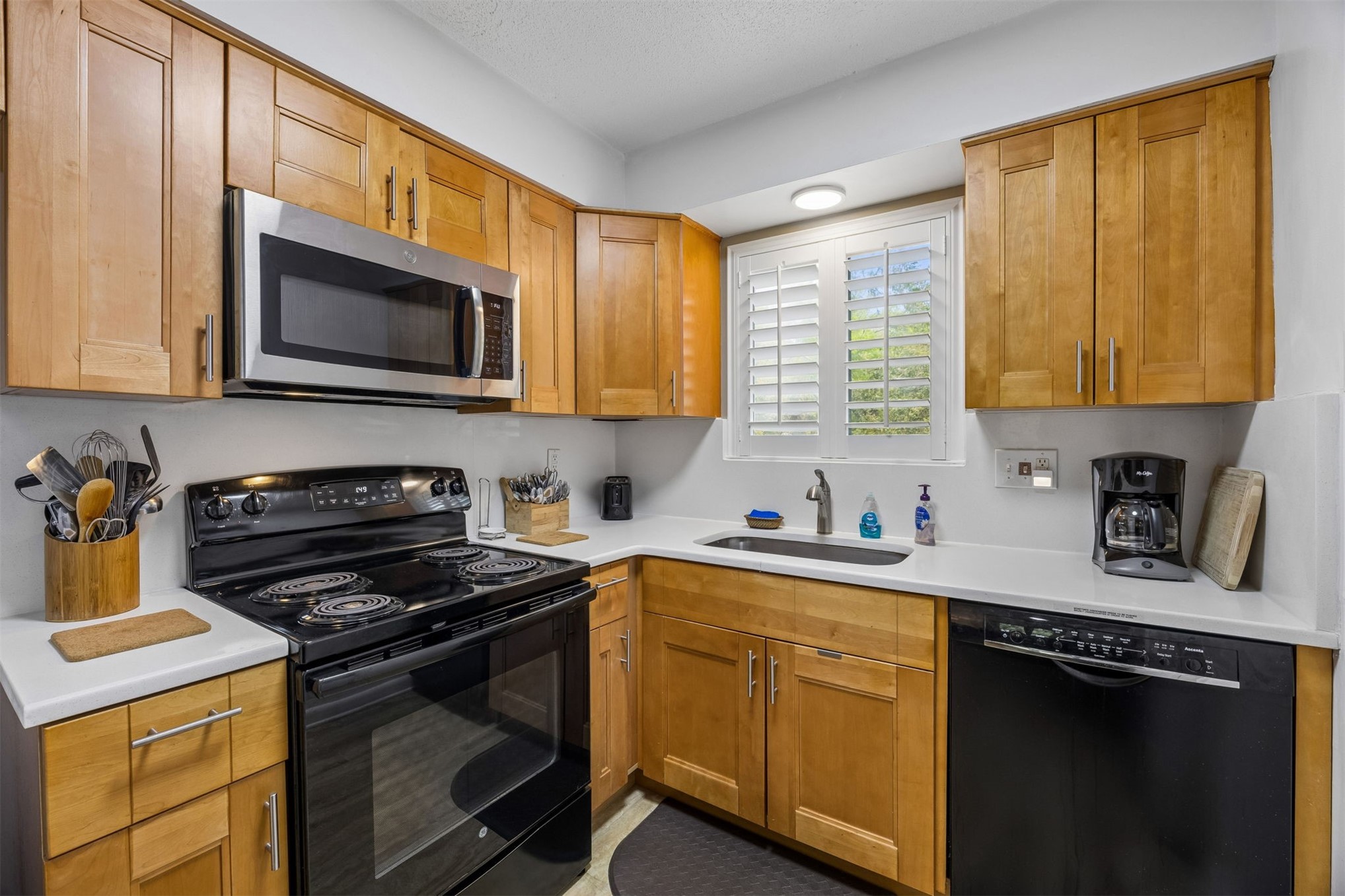 2328 Sadler Road, Unit 1C Fernandina Beach, FL 32034 - Photo 13 of 49 a kitchen with stainless steel appliances granite countertop a stove a sink dishwasher and a microwave