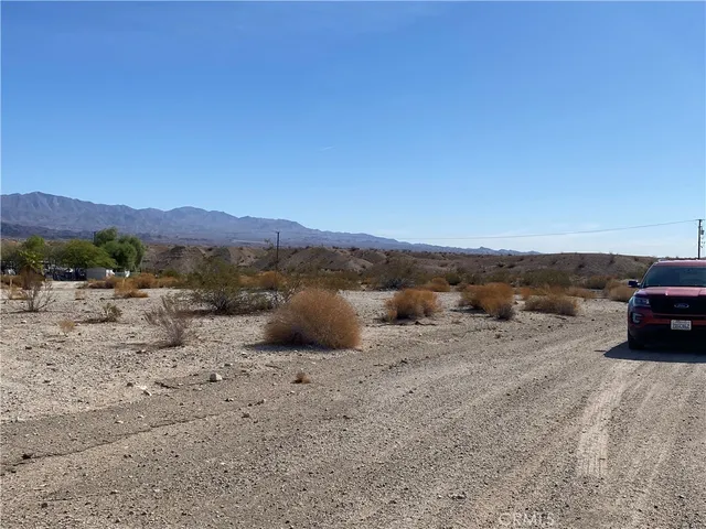a view of a dry car with mountain in the background