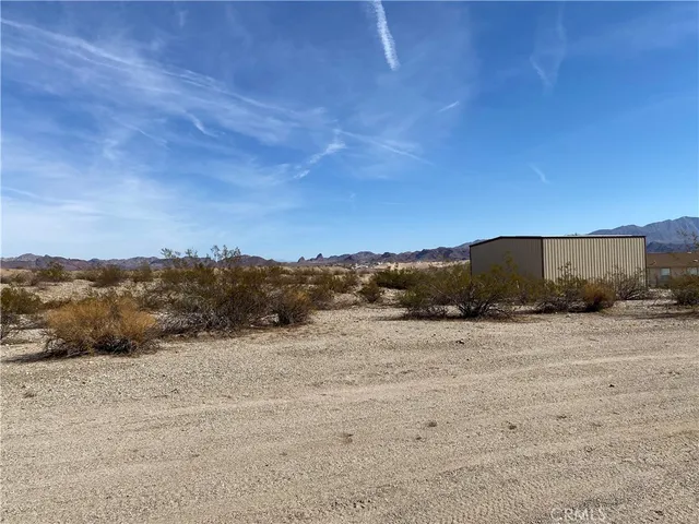 a view of a dry yard with mountain