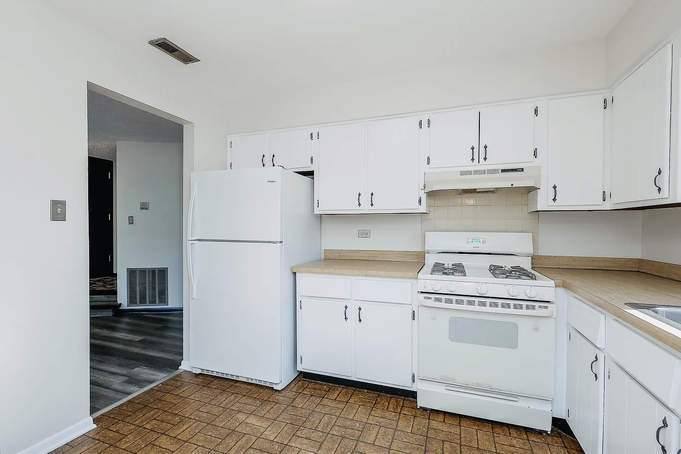 865 Sheldon Court, Unit C Wheaton, IL 60189 - Photo 4 of 11 a kitchen with white cabinets and white appliances