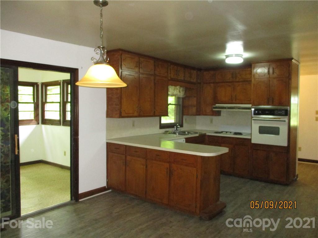 1287 Potter Road Lancaster, SC 29720 - Photo 5 of 25 a kitchen with kitchen island granite countertop a sink and a refrigerator