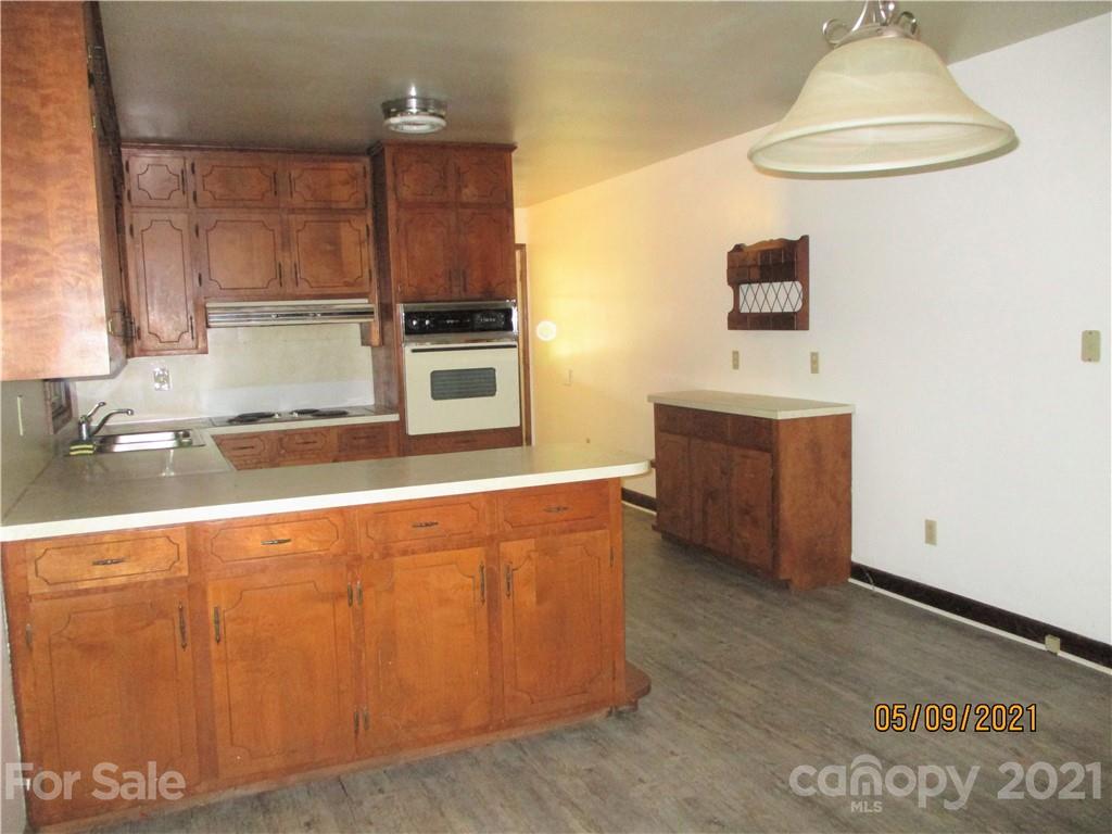 1287 Potter Road Lancaster, SC 29720 - Photo 8 of 25 a kitchen with stainless steel appliances wooden cabinets and a counter top space