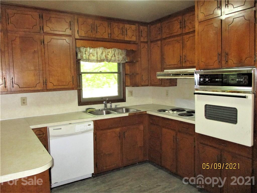 1287 Potter Road Lancaster, SC 29720 - Photo 9 of 25 a kitchen with a stove a sink and a microwave