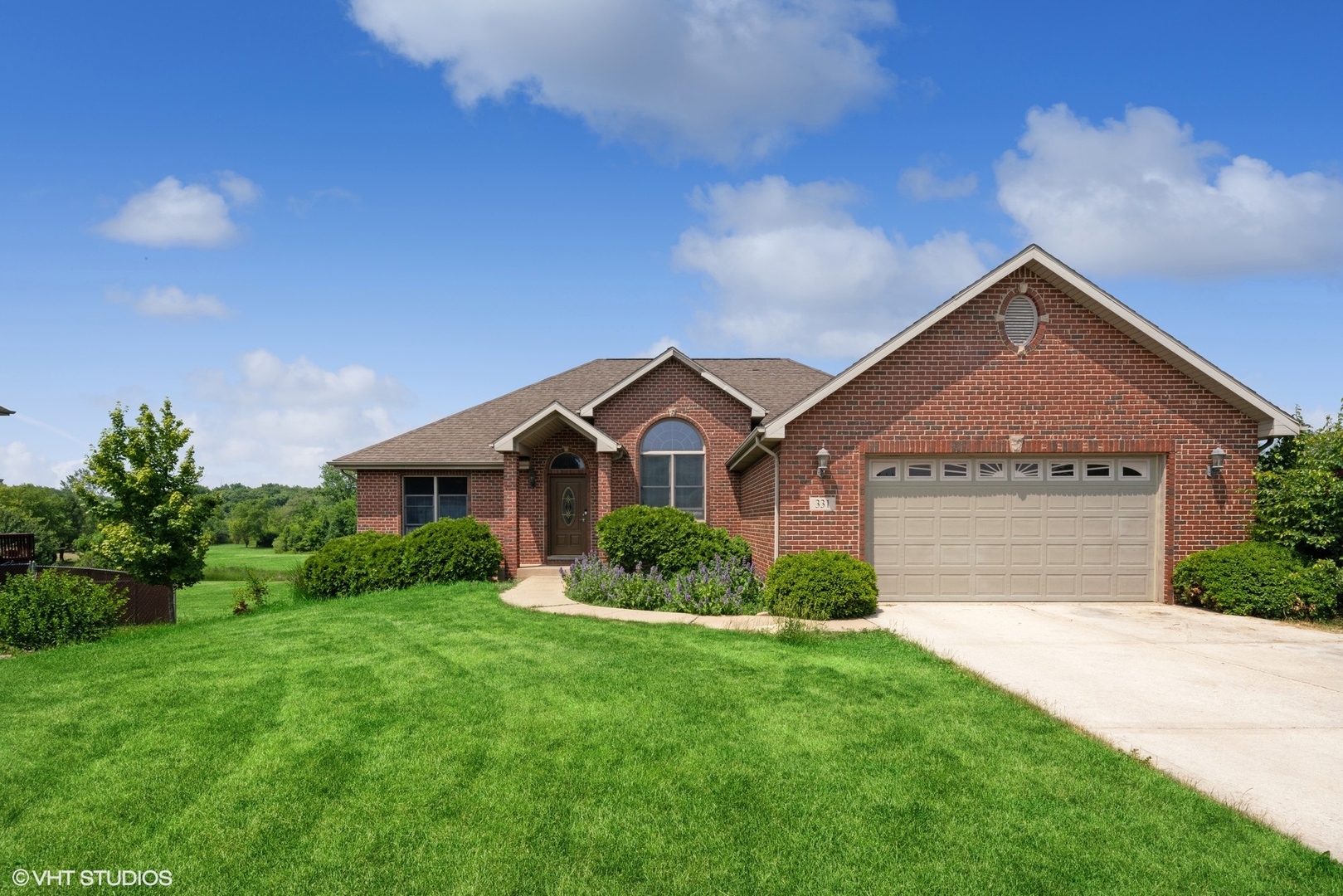 a front view of a house with a yard and garage