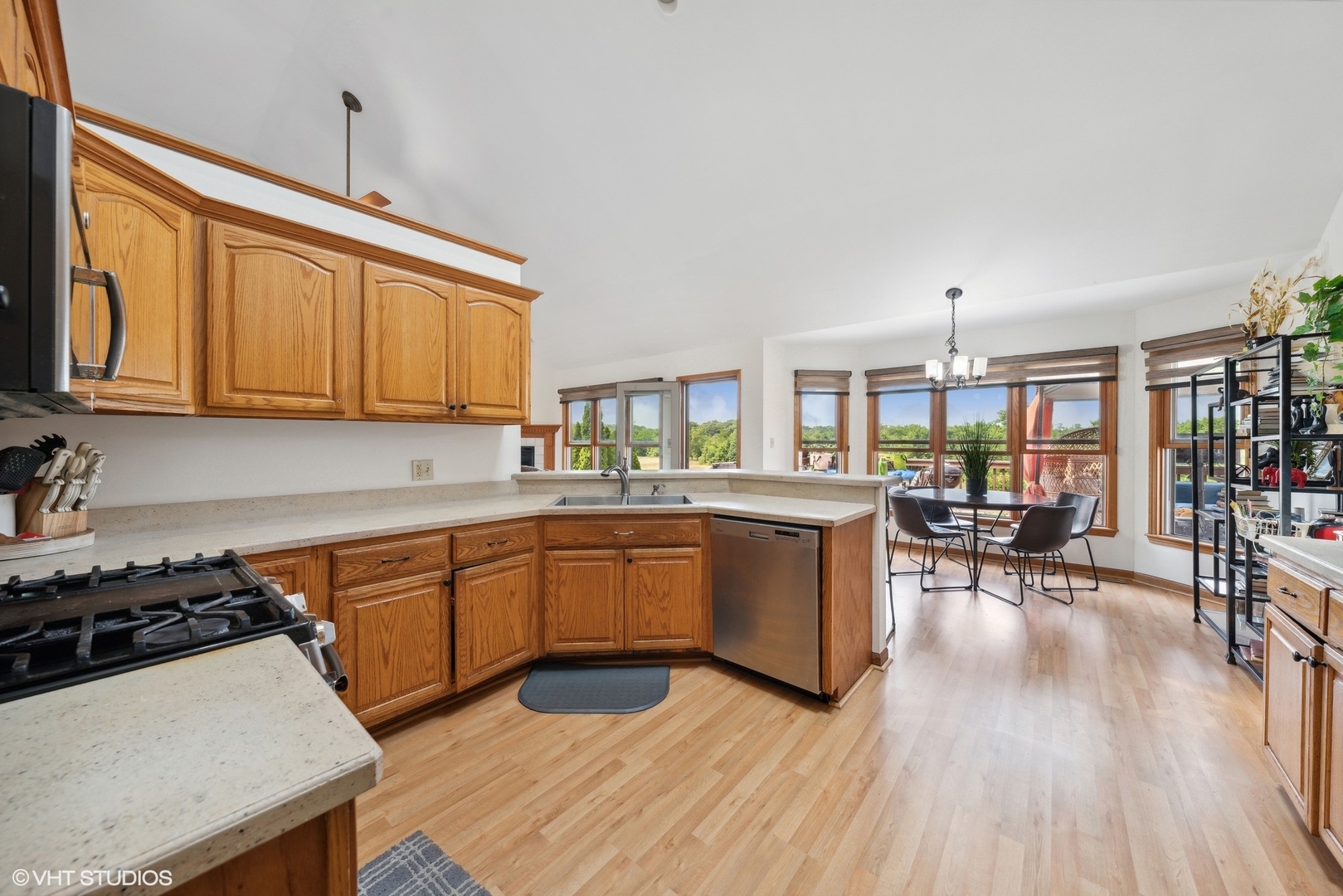331 Coventry Lane Crete, IL 60417 - Photo 9 of 19 a kitchen with stainless steel appliances a stove a sink dishwasher and cabinets with wooden floor