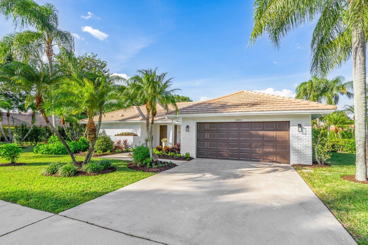 10374 Canoe Brook Circle Boca Raton, FL 33498 - Photo 1 of 41 a front view of house with yard and green space