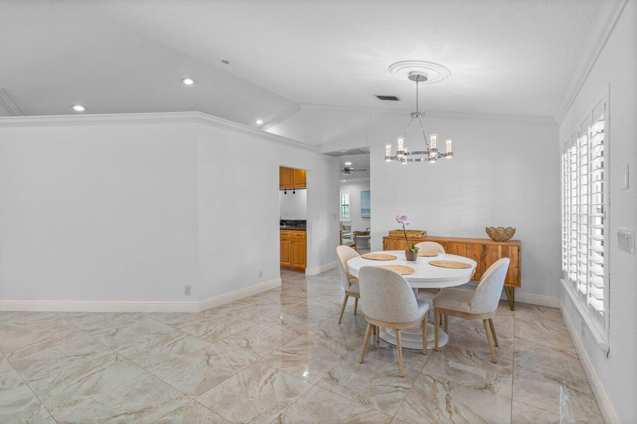 10374 Canoe Brook Circle Boca Raton, FL 33498 - Photo 12 of 41 a view of a dining room with furniture and chandelier