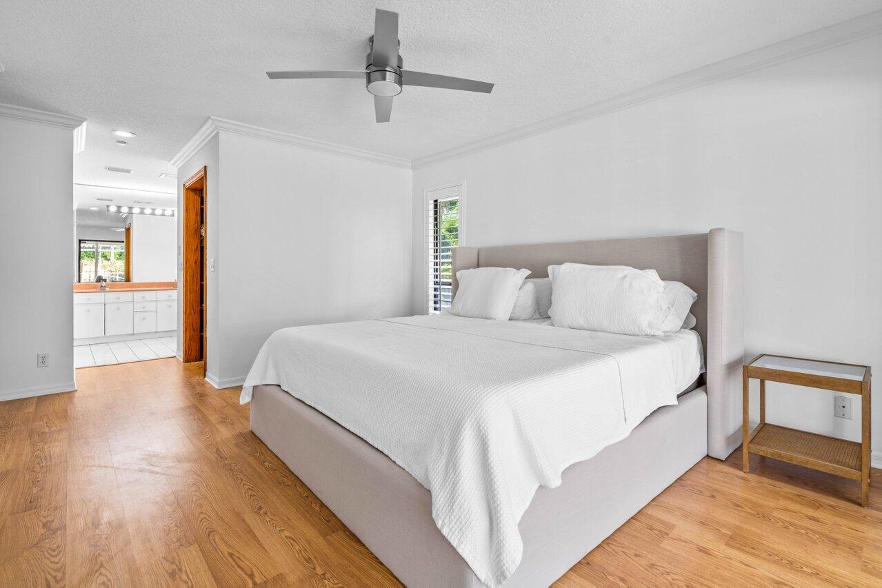 10374 Canoe Brook Circle Boca Raton, FL 33498 - Photo 13 of 41 a bedroom with a bed and wooden floor