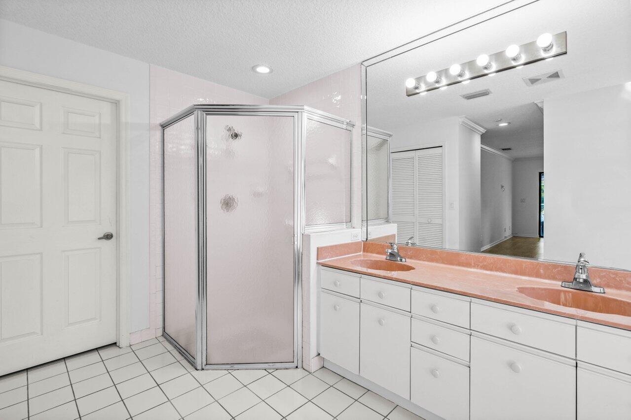 10374 Canoe Brook Circle Boca Raton, FL 33498 - Photo 16 of 41 a bathroom with a double vanity sink mirror and shower