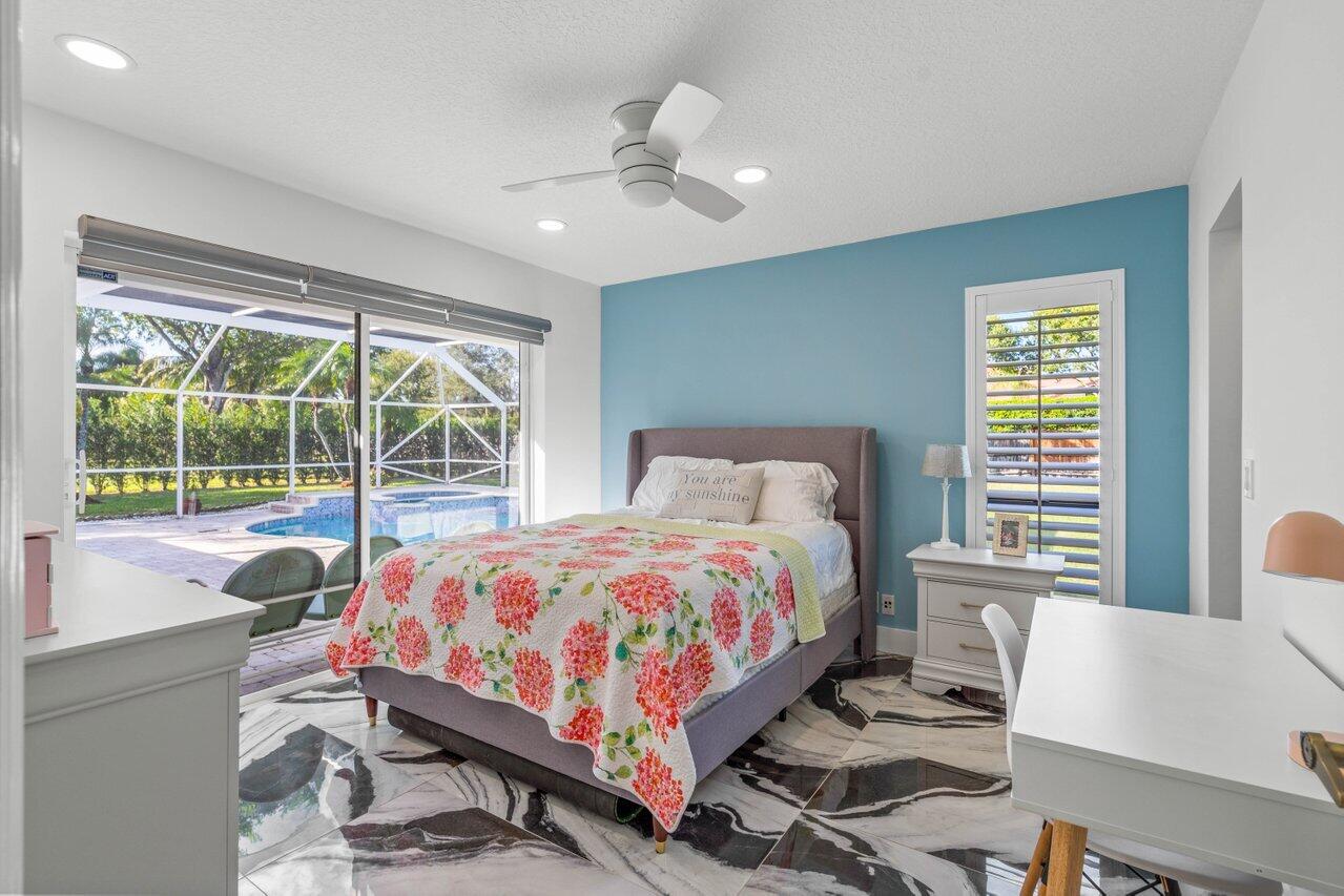 10374 Canoe Brook Circle Boca Raton, FL 33498 - Photo 18 of 41 a bedroom with a bed and a table