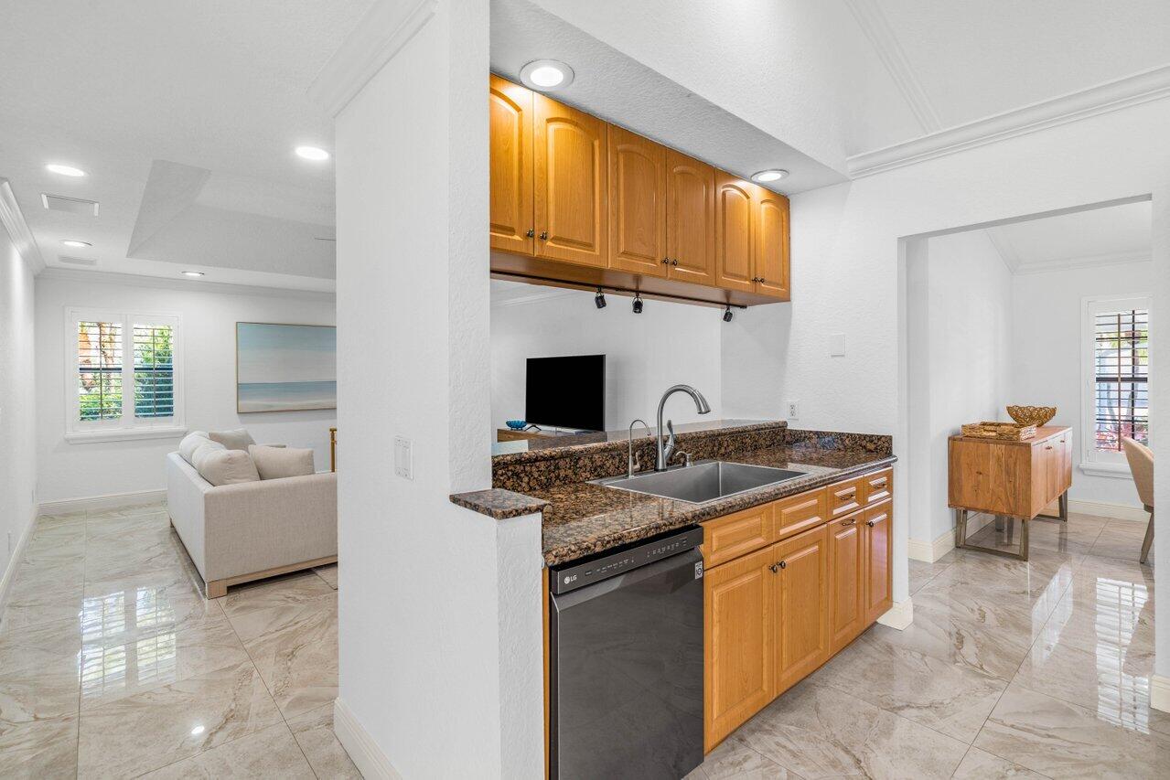10374 Canoe Brook Circle Boca Raton, FL 33498 - Photo 24 of 41 a kitchen with stainless steel appliances granite countertop a sink and a stove
