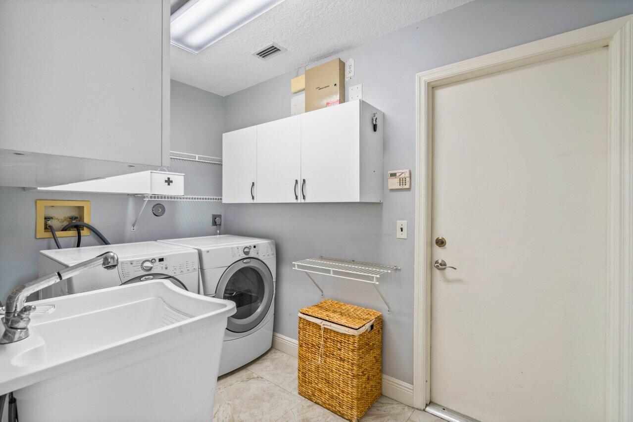 10374 Canoe Brook Circle Boca Raton, FL 33498 - Photo 26 of 41 a utility room with sink dryer and washer