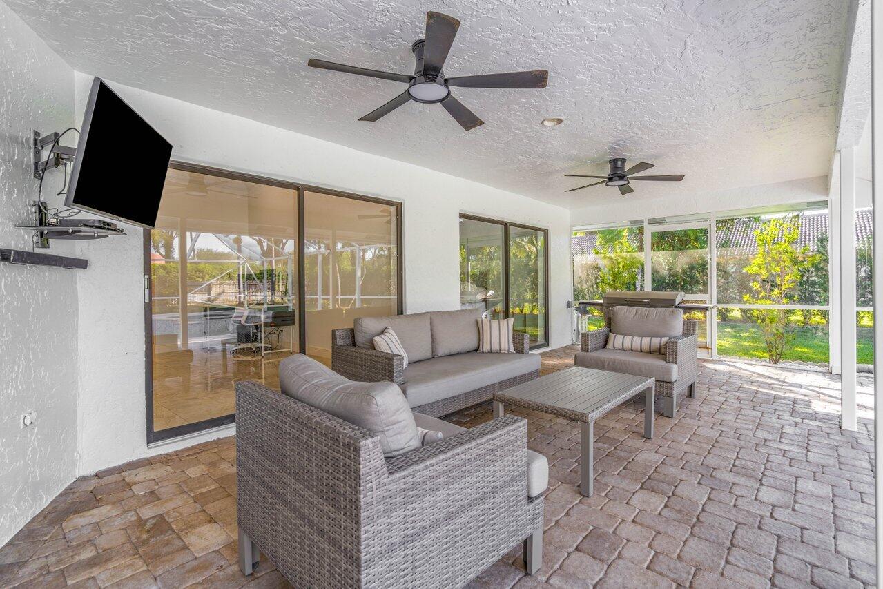 10374 Canoe Brook Circle Boca Raton, FL 33498 - Photo 27 of 41 a living room with fireplace furniture and a flat screen tv