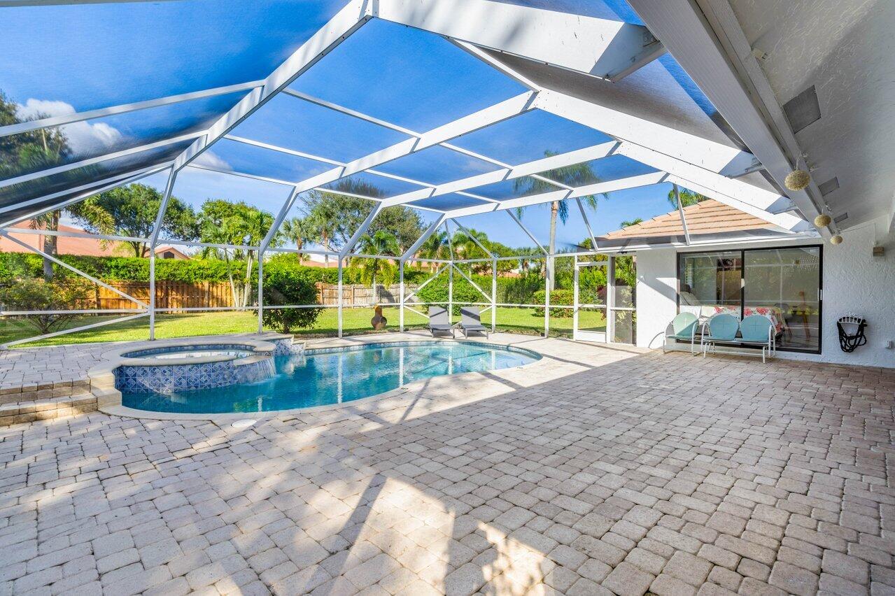 10374 Canoe Brook Circle Boca Raton, FL 33498 - Photo 28 of 41 a view of a backyard with table and chairs under an umbrella