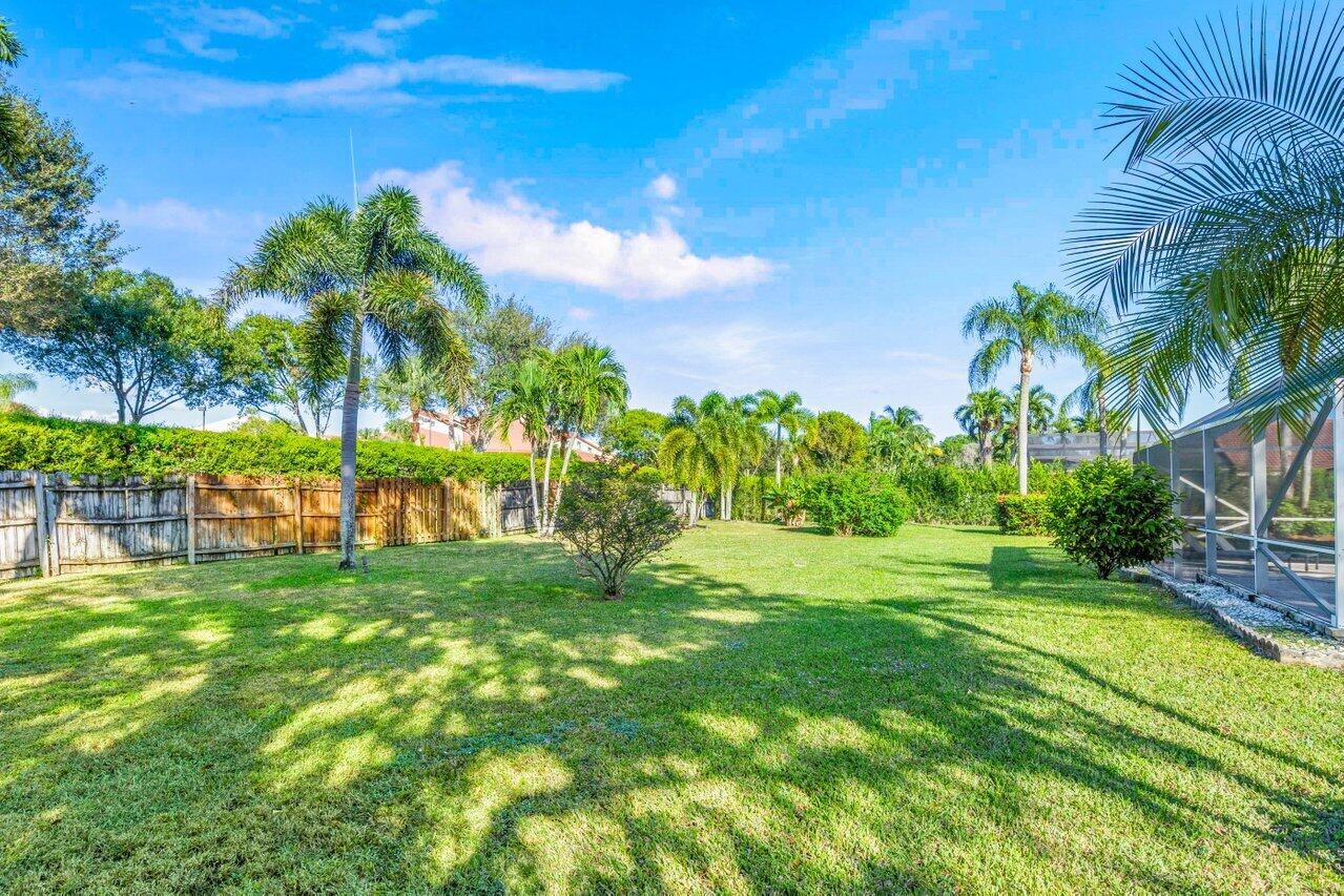 10374 Canoe Brook Circle Boca Raton, FL 33498 - Photo 34 of 41 a view of a garden with a building in the background
