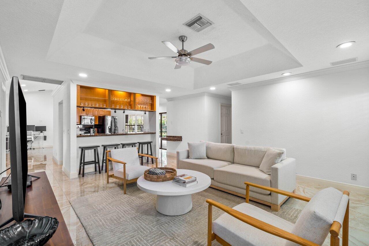 10374 Canoe Brook Circle Boca Raton, FL 33498 - Photo 6 of 41 a living room with furniture and a flat screen tv