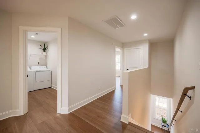 a view of a room with wooden floor and front door