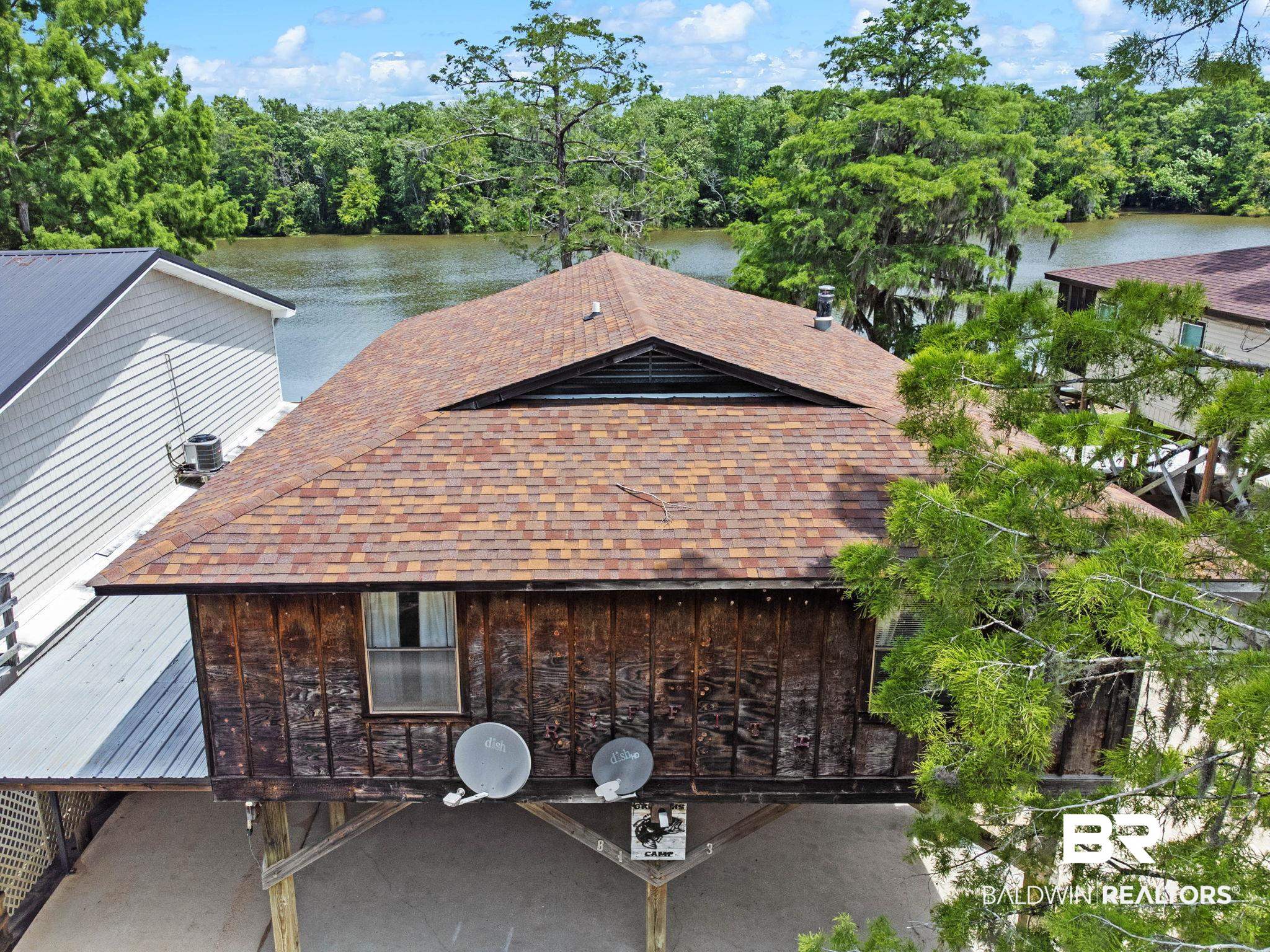 8153 Bryant's Lndg Road Stockton, AL 36579 - Photo 51 of 87 Stilted structure featuring a shingle roof, wood-plank siding, and a single window
