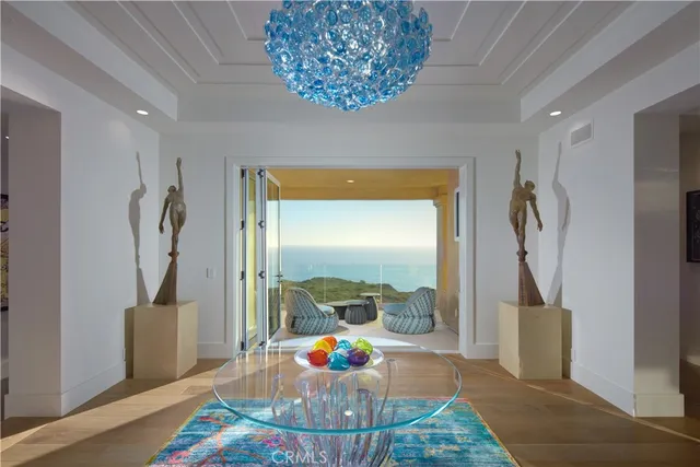 a living room with furniture and a chandelier