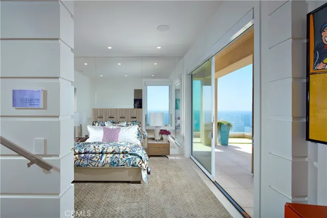 a living room with furniture and a floor to ceiling window