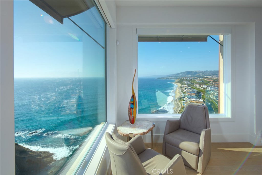 34385 Dana Strand Road, Unit B Dana Point, CA 92629 - Photo 8 of 45 a living room with patio furniture and a floor to ceiling window