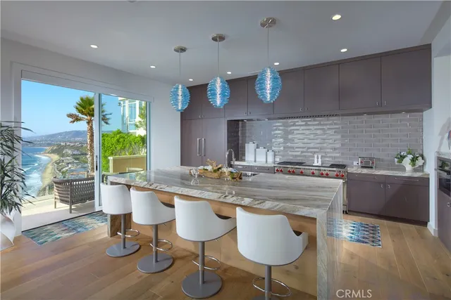 a kitchen with stainless steel appliances granite countertop a sink and a refrigerator