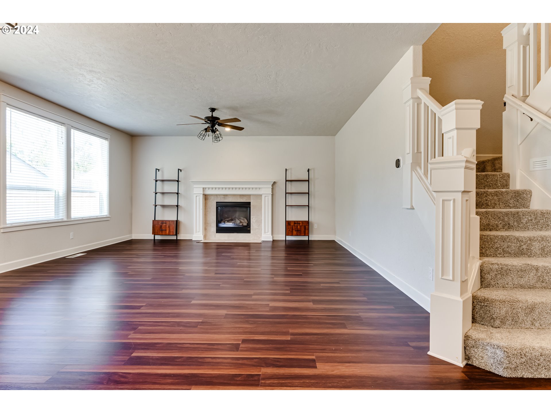 3313 Falcon Drive Springfield, OR 97477 - Photo 13 of 36 an empty room with wooden floor fireplace and windows