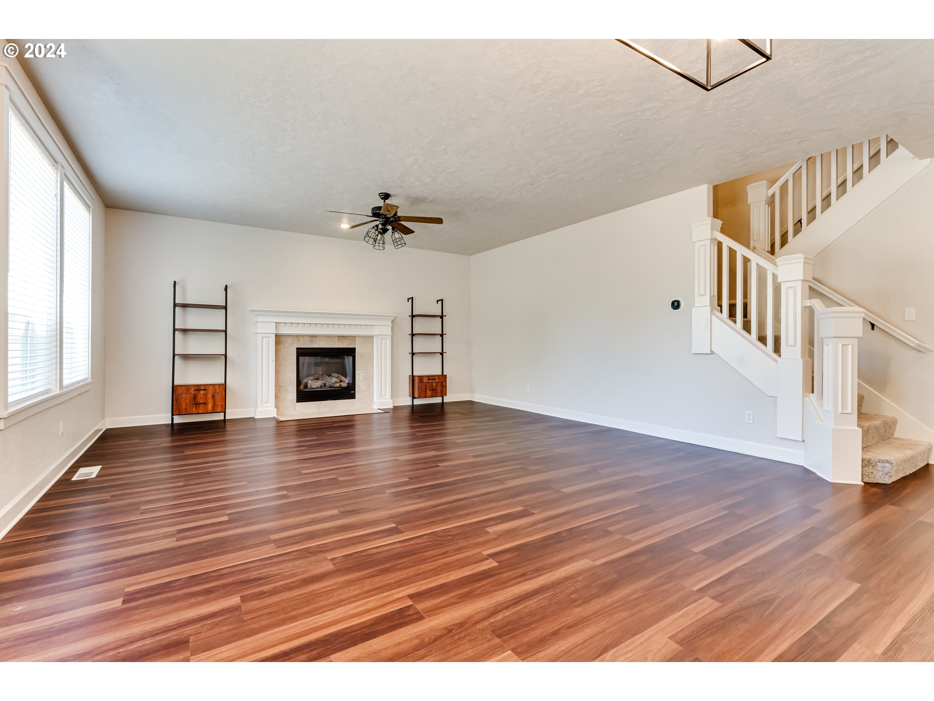 3313 Falcon Drive Springfield, OR 97477 - Photo 14 of 36 a view of an empty room with wooden floor and fireplace