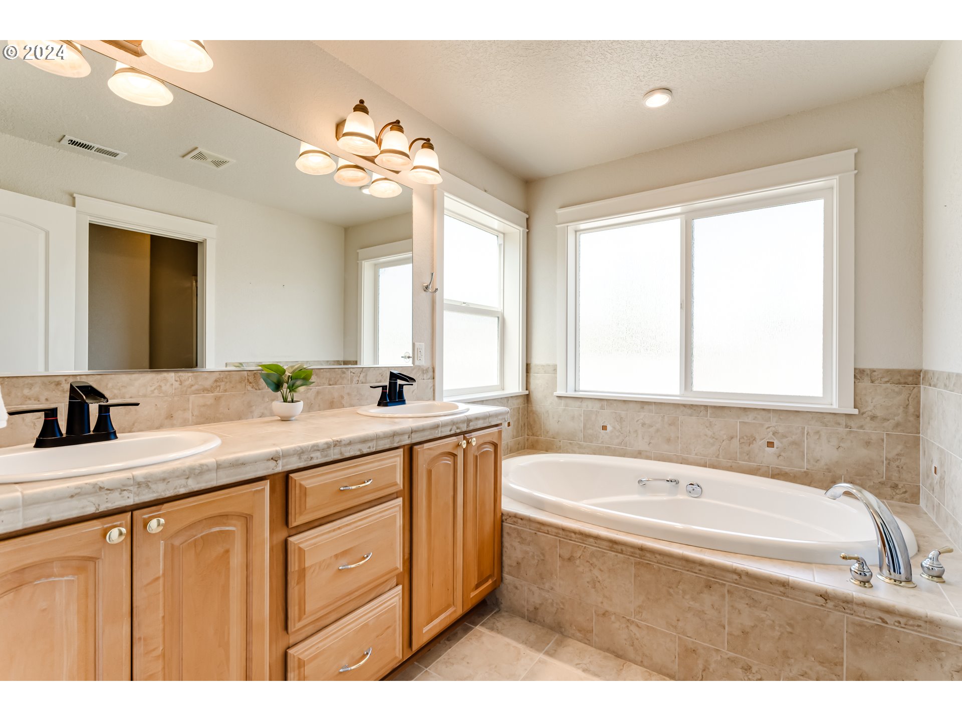 3313 Falcon Drive Springfield, OR 97477 - Photo 19 of 36 a bathroom with a tub a sink double vanity and a mirror