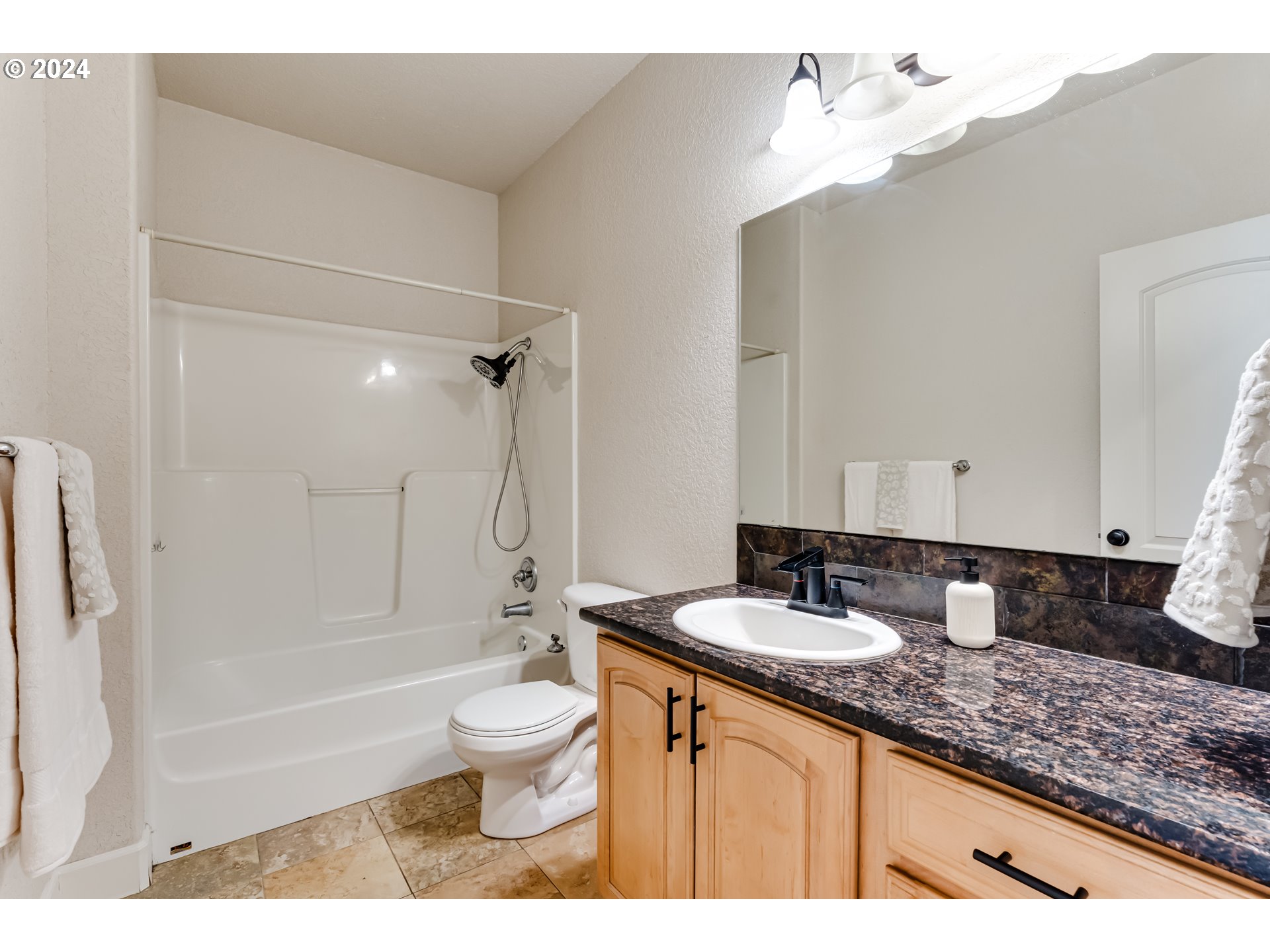 3313 Falcon Drive Springfield, OR 97477 - Photo 6 of 36 a bathroom with a granite countertop sink a toilet and bathtub