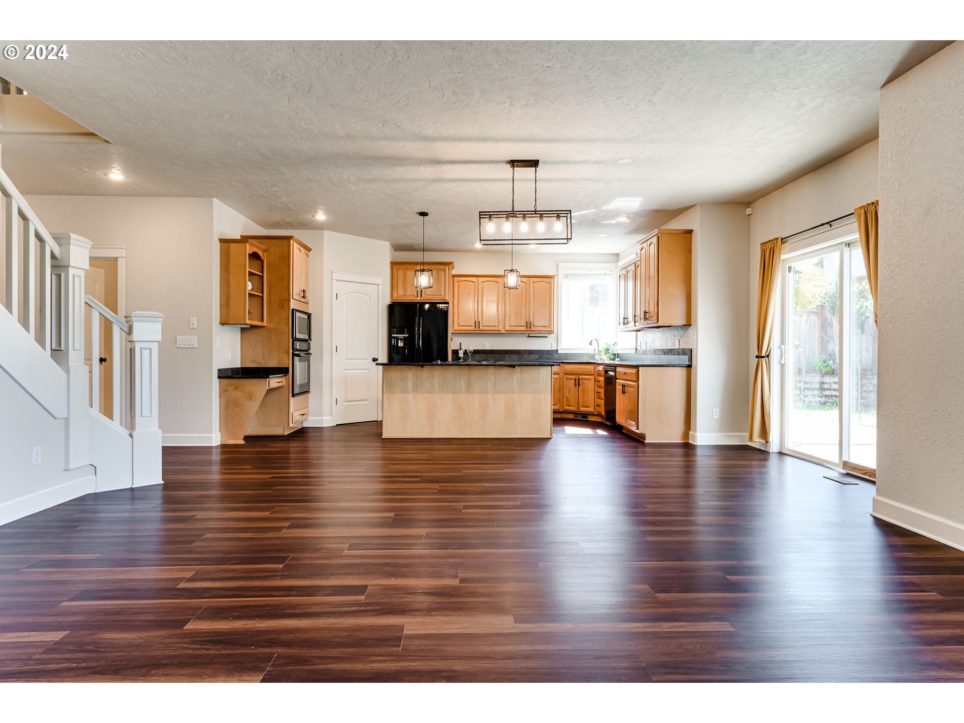 3313 Falcon Drive Springfield, OR 97477 - Photo 7 of 36 a view of a living room a kitchen island wooden floor and a window