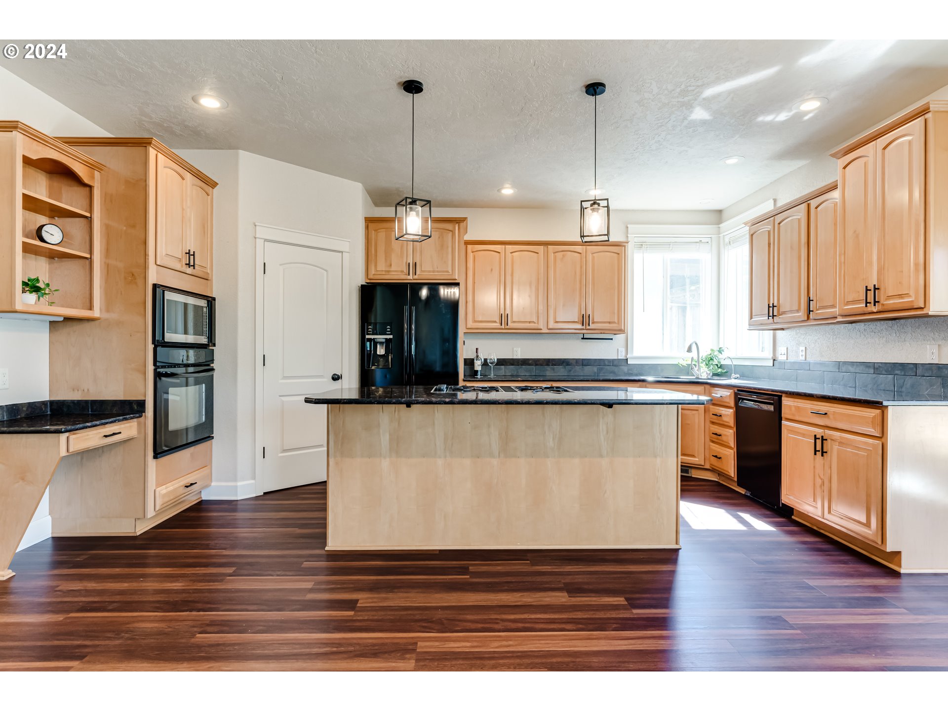 3313 Falcon Drive Springfield, OR 97477 - Photo 8 of 36 a kitchen with stainless steel appliances granite countertop a refrigerator a sink dishwasher a stove and white countertops with wooden floor
