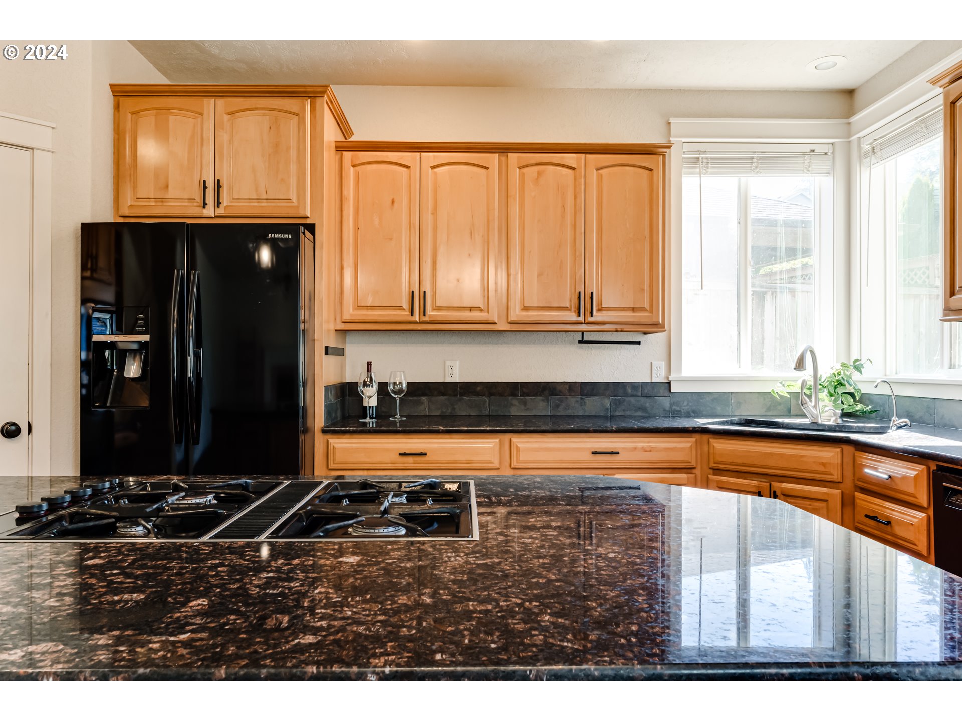 3313 Falcon Drive Springfield, OR 97477 - Photo 10 of 36 a kitchen with granite countertop a refrigerator and a sink