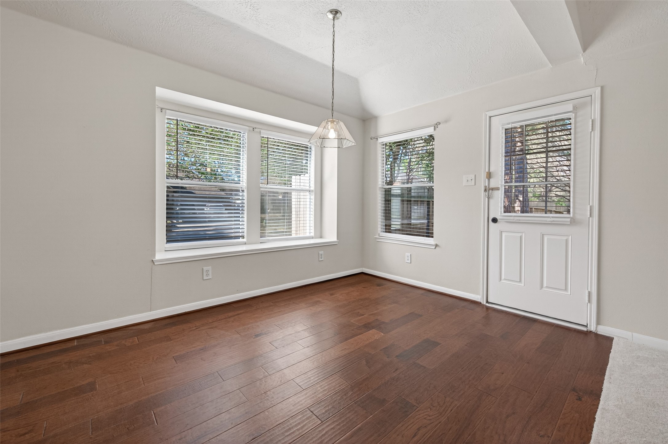 39 North Delta Mill Circle Conroe, TX 77385 - Photo 13 of 35 an empty room with wooden floor and windows