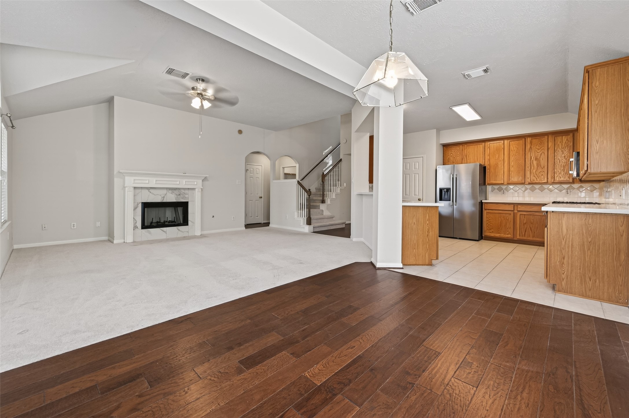 39 North Delta Mill Circle Conroe, TX 77385 - Photo 14 of 35 a view of a livingroom with a fireplace wooden floor and chandelier