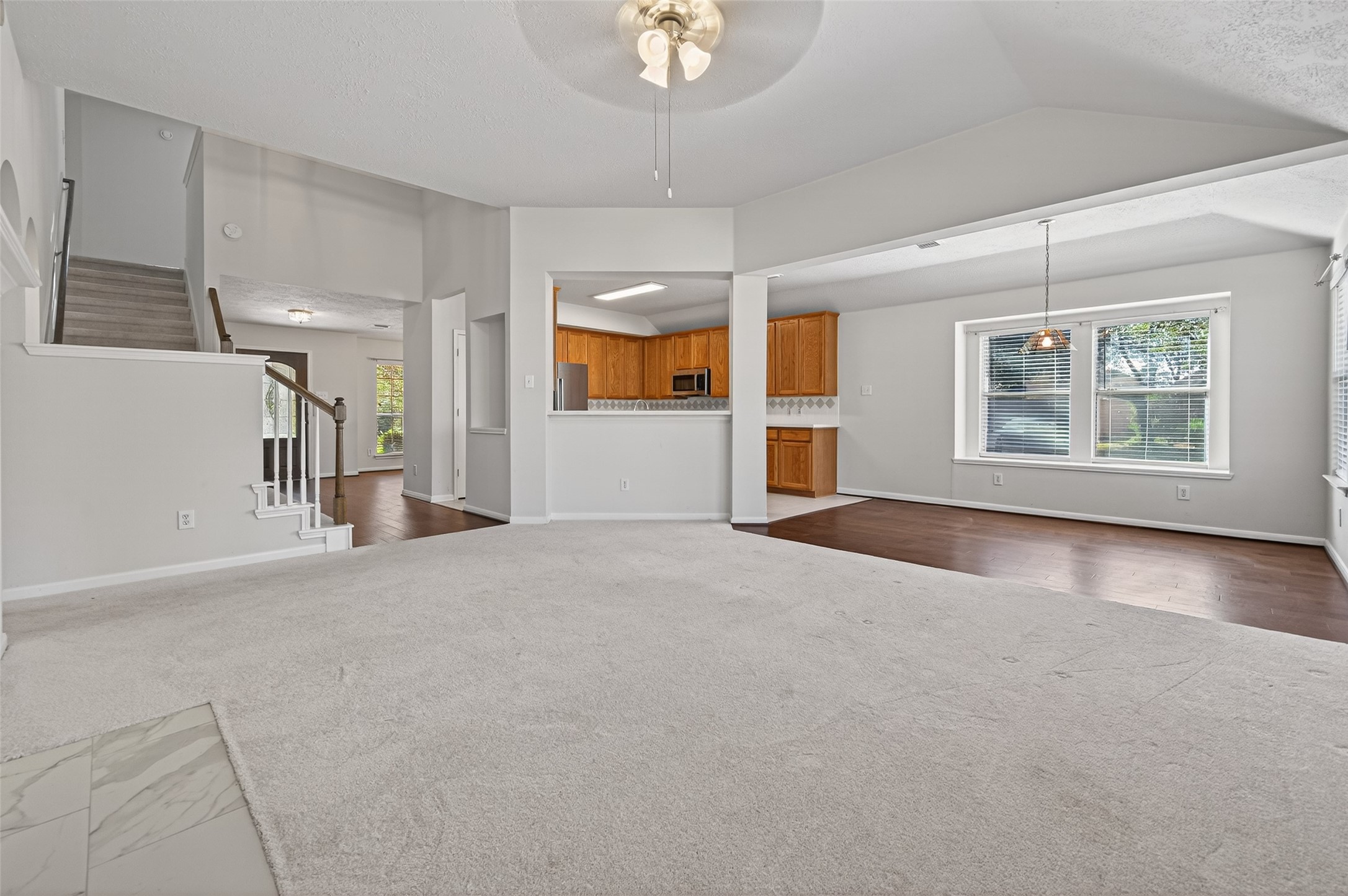 39 North Delta Mill Circle Conroe, TX 77385 - Photo 16 of 35 an empty room with chandelier fan and windows