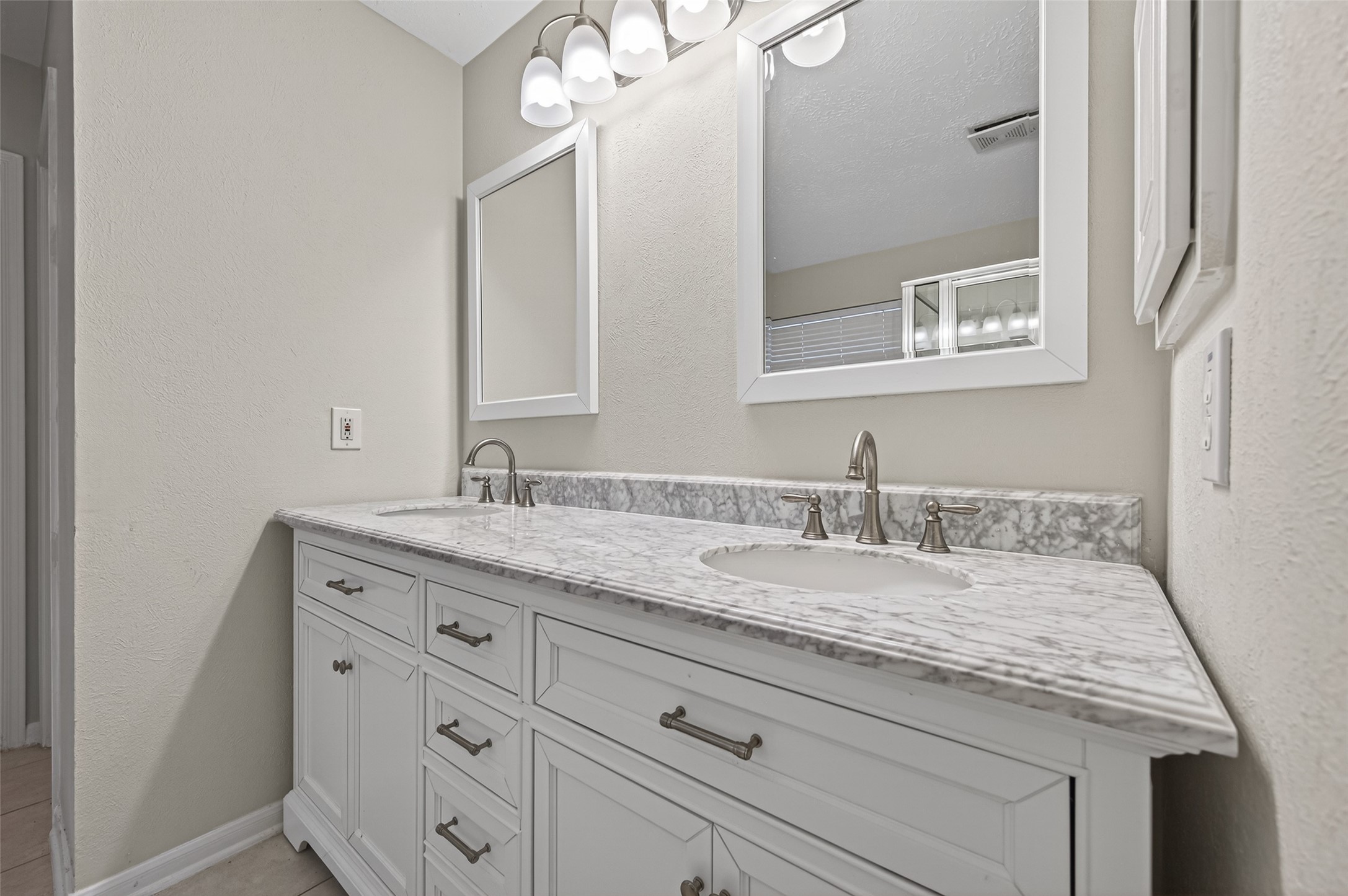 39 North Delta Mill Circle Conroe, TX 77385 - Photo 23 of 35 a bathroom with a granite countertop sink and a mirror