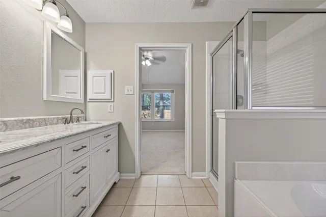 a bathroom with a granite countertop sink a mirror and a