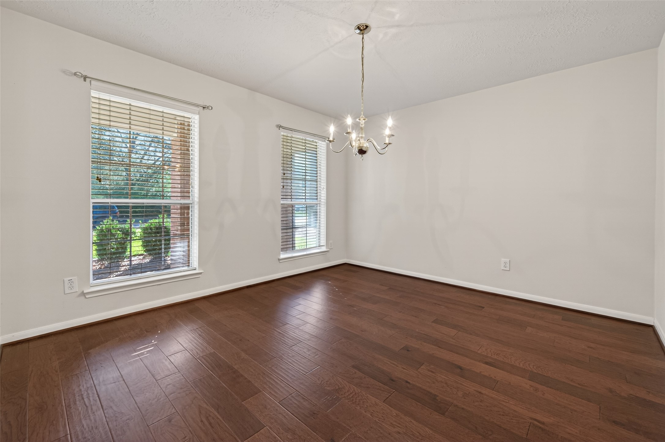 39 North Delta Mill Circle Conroe, TX 77385 - Photo 5 of 35 wooden floor in an empty room with a window