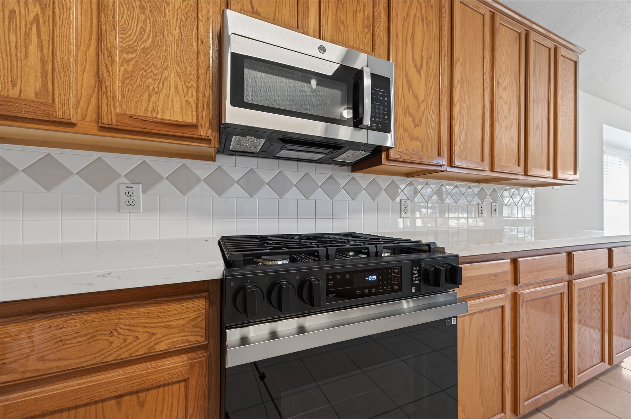 39 North Delta Mill Circle Conroe, TX 77385 - Photo 10 of 35 a kitchen with stainless steel appliances granite countertop white cabinets and a stove top oven