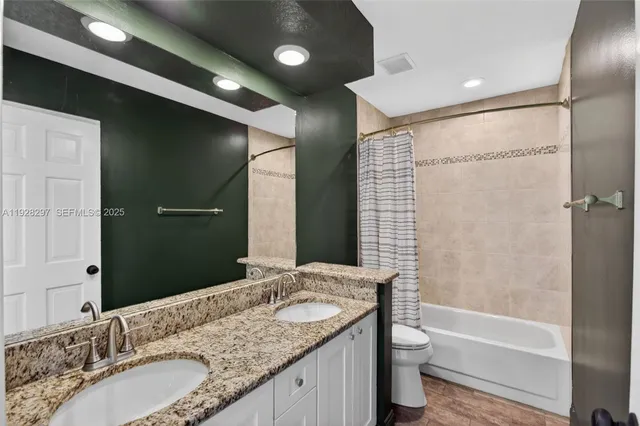 a open kitchen with stainless steel appliances granite countertop a stove a sink dishwasher and cabinets with wooden floor