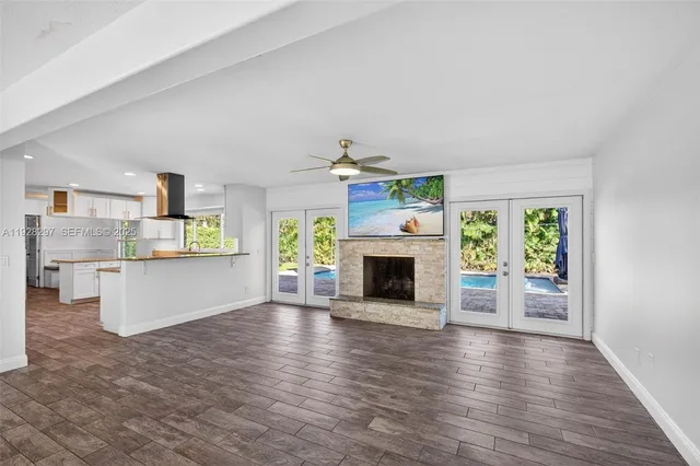 an aerial view of residential houses with outdoor space and trees
