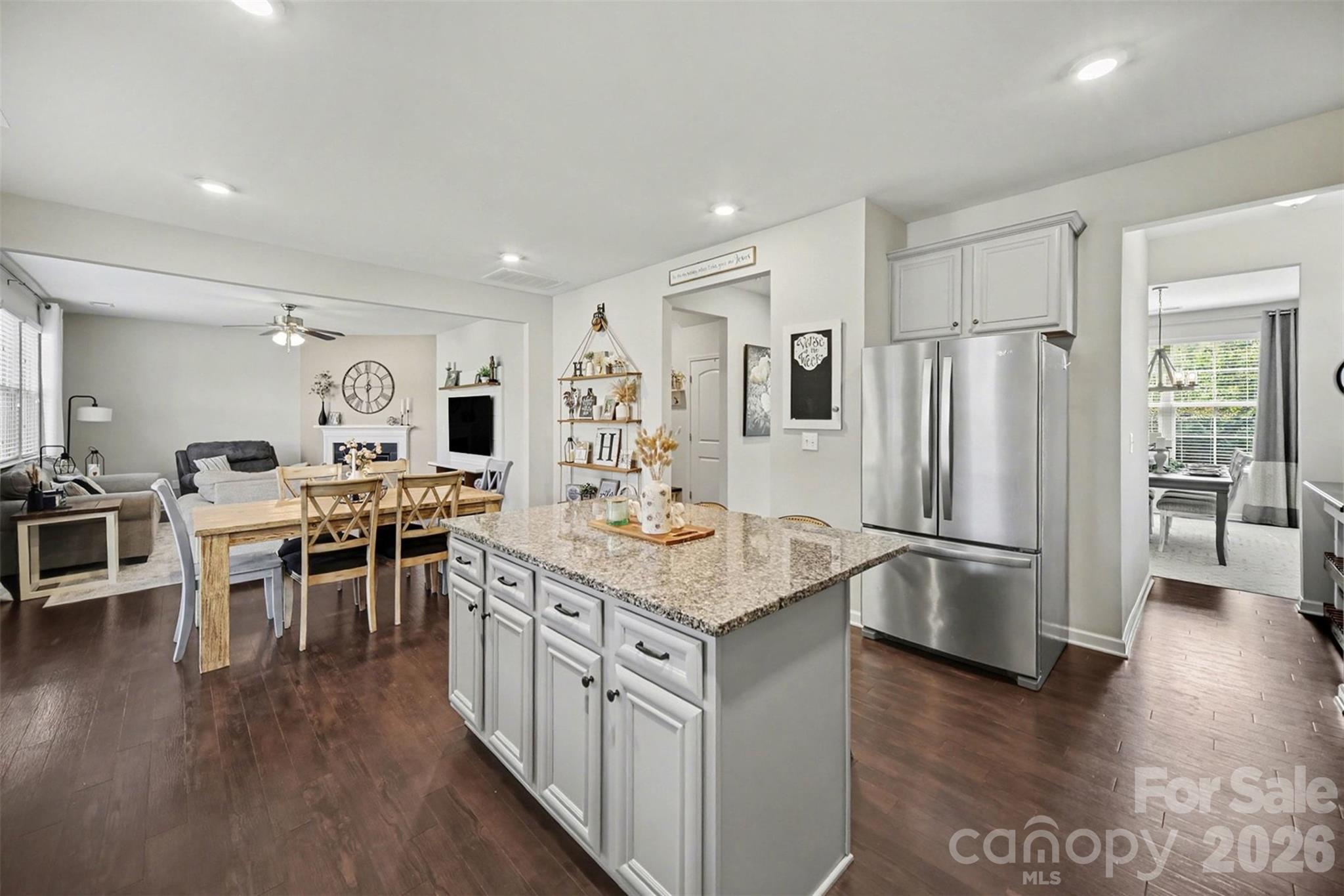 514 Tack Lane Midland, NC 28107 - Photo 12 of 48 a kitchen with stainless steel appliances granite countertop a stove refrigerator and a dining table with wooden floor